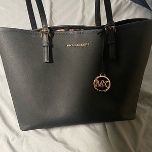 Black michael kors purse with cheetah inside